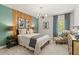 Comfortable bedroom featuring a wood accent wall, patterned curtains and stylish decor at 400 Brooch Way, Stockbridge, GA 30281