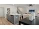 Modern kitchen featuring an island, stainless steel appliances, and views into the living room at 400 Brooch Way, Stockbridge, GA 30281