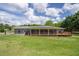 Expansive backyard featuring a screened-in porch, wooden deck, and a wrought iron fence at 220 Pitts Chapel Rd, Newborn, GA 30056