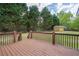 Scenic backyard view from deck, featuring lush trees, a charming shed, and ample green space at 220 Pitts Chapel Rd, Newborn, GA 30056