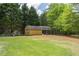 Backyard view of the barn, trees and the wrought iron fence at 220 Pitts Chapel Rd, Newborn, GA 30056