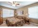 Serene bedroom with a ceiling fan, two large windows, and comfortable bedding at 220 Pitts Chapel Rd, Newborn, GA 30056