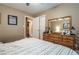 Bright bedroom showcasing a dresser, large mirror, and comfortable queen bed at 220 Pitts Chapel Rd, Newborn, GA 30056