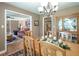 Open dining room area with hardwood floors and a wooden table set for a meal at 220 Pitts Chapel Rd, Newborn, GA 30056