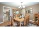 Elegant dining room with a wooden table, chairs, hardwood floors, and adjacent kitchen at 220 Pitts Chapel Rd, Newborn, GA 30056