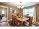 Cozy dining room features a wooden table, chandelier, and natural light from the window at 220 Pitts Chapel Rd, Newborn, GA 30056