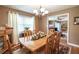 Inviting dining room featuring a wooden table, chandelier, and neutral color scheme at 220 Pitts Chapel Rd, Newborn, GA 30056