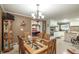 Traditional dining room featuring elegant chandelier, glass table, and adjacent kitchen and game room at 220 Pitts Chapel Rd, Newborn, GA 30056