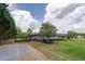 Home featuring a secure gated entrance and a long driveway leading to the residence surrounded by greenery at 220 Pitts Chapel Rd, Newborn, GA 30056