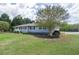 Well-manicured front yard with mature trees highlighting the home's charming curb appeal and landscape design at 220 Pitts Chapel Rd, Newborn, GA 30056