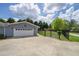Exterior view featuring a side-entry garage, fenced yard, and well-maintained landscaping at 220 Pitts Chapel Rd, Newborn, GA 30056