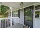 Covered front porch with a storm door, offering a warm welcome and protection from the elements at 220 Pitts Chapel Rd, Newborn, GA 30056