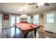 Spacious game room with pool table, ceiling fan, and natural light from glass doors to the exterior at 220 Pitts Chapel Rd, Newborn, GA 30056