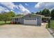 Attached garage with a concrete driveway, complemented by manicured landscaping and a gated entrance at 220 Pitts Chapel Rd, Newborn, GA 30056