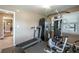Home gym featuring a ceiling fan, treadmill, weight machine, and access to another room at 220 Pitts Chapel Rd, Newborn, GA 30056