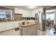 Well-lit kitchen with an island, white cabinets, and stainless steel refrigerator at 220 Pitts Chapel Rd, Newborn, GA 30056
