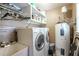 Functional laundry room with washer, dryer, utility sink, and shelving for storage of supplies at 220 Pitts Chapel Rd, Newborn, GA 30056