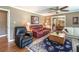 Cozy living room with hardwood floors, a ceiling fan, and comfortable seating arrangement at 220 Pitts Chapel Rd, Newborn, GA 30056