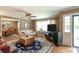 Bright living room featuring hardwood floors, a ceiling fan, and direct access to the dining area at 220 Pitts Chapel Rd, Newborn, GA 30056