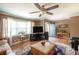 Welcoming living room with hardwood floors, a ceiling fan, and ample natural light streaming through the windows at 220 Pitts Chapel Rd, Newborn, GA 30056
