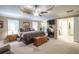 Bright main bedroom with tray ceiling, carpet flooring, and access to an attached bathroom at 220 Pitts Chapel Rd, Newborn, GA 30056