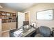 Inviting home office with a built-in bookcase, desk, and Lake Sinclair map at 220 Pitts Chapel Rd, Newborn, GA 30056