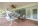 Welcoming screened porch with rocking chairs, dining table, and comfortable seating area at 220 Pitts Chapel Rd, Newborn, GA 30056