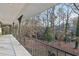 Open balcony with metal railing overlooking backyard with mature trees at 2667 Fieldstone Se Dr, Conyers, GA 30013