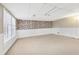 Spacious basement with brick accent wall and large window at 2667 Fieldstone Se Dr, Conyers, GA 30013