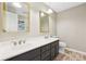 Bathroom featuring a double sink vanity with framed mirrors and brushed nickel fixtures at 2667 Fieldstone Se Dr, Conyers, GA 30013