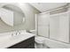 Modern bathroom with a sleek vanity, round mirror, and glass-enclosed shower at 2667 Fieldstone Se Dr, Conyers, GA 30013
