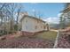 Landscaped backyard with a two-story home that features tan siding at 2667 Fieldstone Se Dr, Conyers, GA 30013