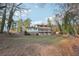 View of multi-story home surrounded by mature trees, adding privacy and natural beauty to the property at 2667 Fieldstone Se Dr, Conyers, GA 30013