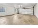 Spacious garage with windows and a large roll-up door, ready for your projects at 2667 Fieldstone Se Dr, Conyers, GA 30013