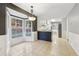 Eat-in kitchen with large bay window, tile flooring, and updated lighting fixtures offering a cozy space at 2667 Fieldstone Se Dr, Conyers, GA 30013