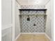 Laundry area with black and white patterned wall covering and shelving at 2667 Fieldstone Se Dr, Conyers, GA 30013