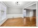 Living room with neutral paint, wooden floors, and modern light fixture perfect for entertaining at 2667 Fieldstone Se Dr, Conyers, GA 30013