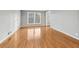 Bright living room featuring shiny hardwood floors and large windows at 2667 Fieldstone Se Dr, Conyers, GA 30013