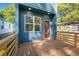 Cozy backyard deck area with blue siding, wooden fence and a red door for easy access at 281 Griffin Nw St, Atlanta, GA 30314