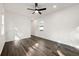 Large bedroom featuring hardwood floors, white walls, a ceiling fan, and a charming small door access at 281 Griffin Nw St, Atlanta, GA 30314