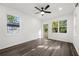 Bright bedroom with hardwood floors and a ceiling fan boasting ample natural light from the large windows at 281 Griffin Nw St, Atlanta, GA 30314