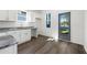 Well-lit, bright kitchen with white cabinets and modern fixtures, window, and outside entrance at 281 Griffin Nw St, Atlanta, GA 30314