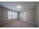 Neutral bedroom with soft gray walls, plush carpeting, and sunny windows at 4320 Royal Mustang Way, Snellville, GA 30039