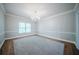 A cozy bedroom featuring neutral carpet, large windows providing ample natural light, and custom trim at 4320 Royal Mustang Way, Snellville, GA 30039