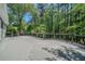 Large, gray stained deck, ideal for relaxing and enjoying the surrounding wooded area at 4320 Royal Mustang Way, Snellville, GA 30039