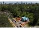 Aerial view of home construction site surrounded by lush trees, with a city skyline in the distance at 469 Emily Reed Ln, Atlanta, GA 30342