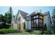 Landscaped painted brick home featuring an arched entryway and a black framed modern window feature at 469 Emily Reed Ln, Atlanta, GA 30342