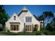 Charming painted brick home with a manicured lawn, arched entryway, and black framed modern window feature at 469 Emily Reed Ln, Atlanta, GA 30342