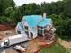 New home exterior featuring a roof with blue covering, scaffolding, and a brick accent wall, situated on a construction site at 469 Emily Reed Lot 11 Ln, Atlanta, GA 30342