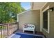 Back porch with an outdoor rug and a charming white bench, offering a cozy spot to relax outdoors at 734 Frasier Se Cir, Marietta, GA 30060